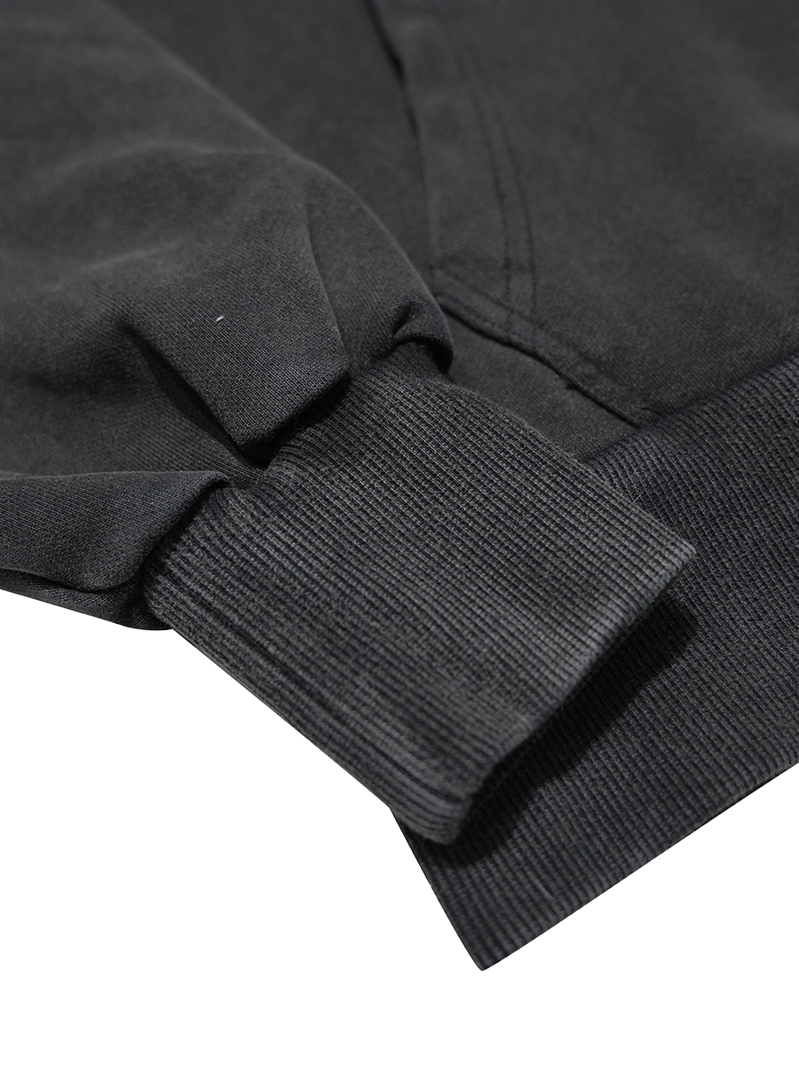 Close-up of a black jacket sleeve on a white background