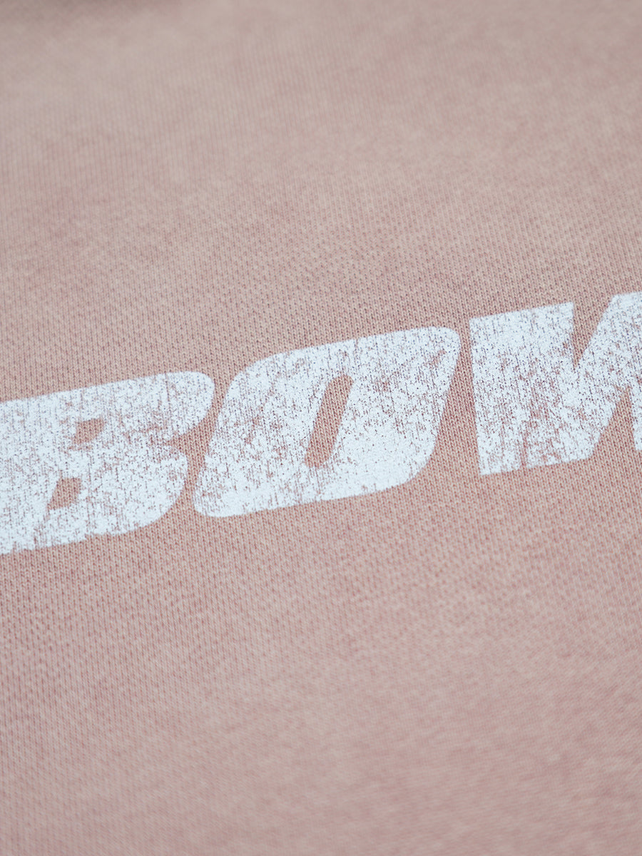 Close-up of a pink fabric with 'BOWI' printed in white.