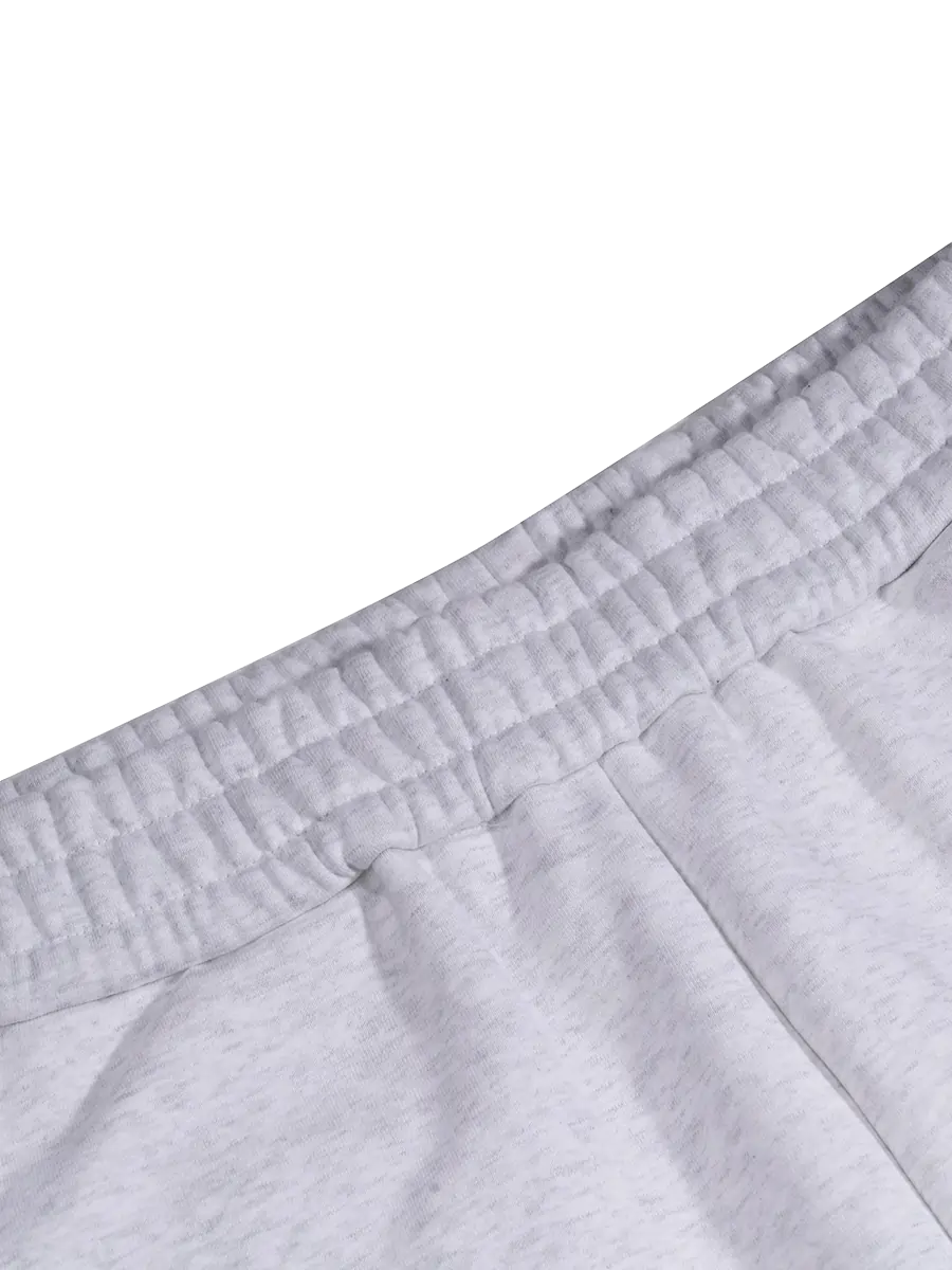 Close-up of gray sweatpants with a white background