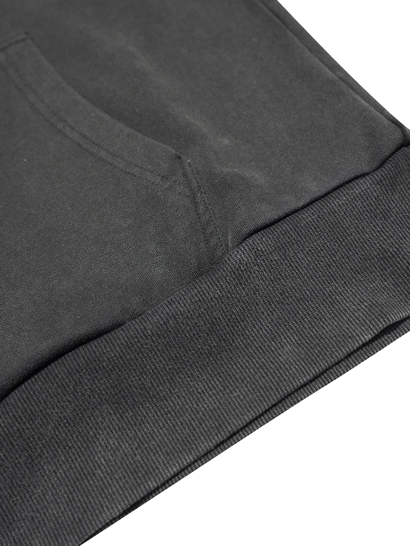Close-up of a dark gray sweatshirt with ribbed cuffs on a white background