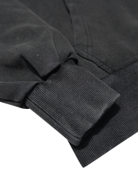 Close-up of a black jacket sleeve on a white background