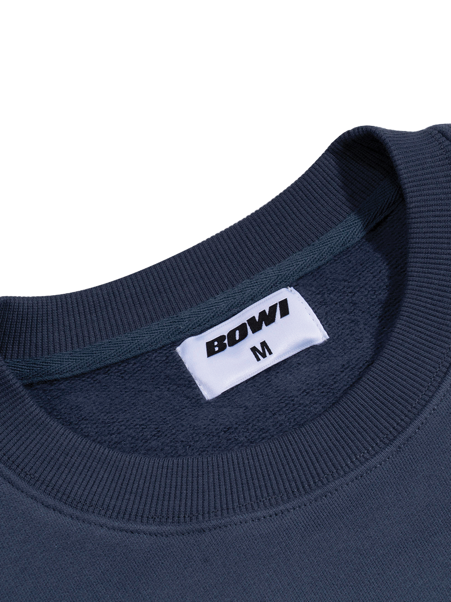 Navy blue sweatshirt with a white label displaying 'BOWI' and size 'M' on a white background.