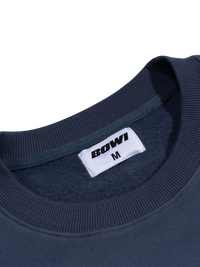 Navy blue sweatshirt with a white label displaying 'BOWI' and size 'M' on a white background.