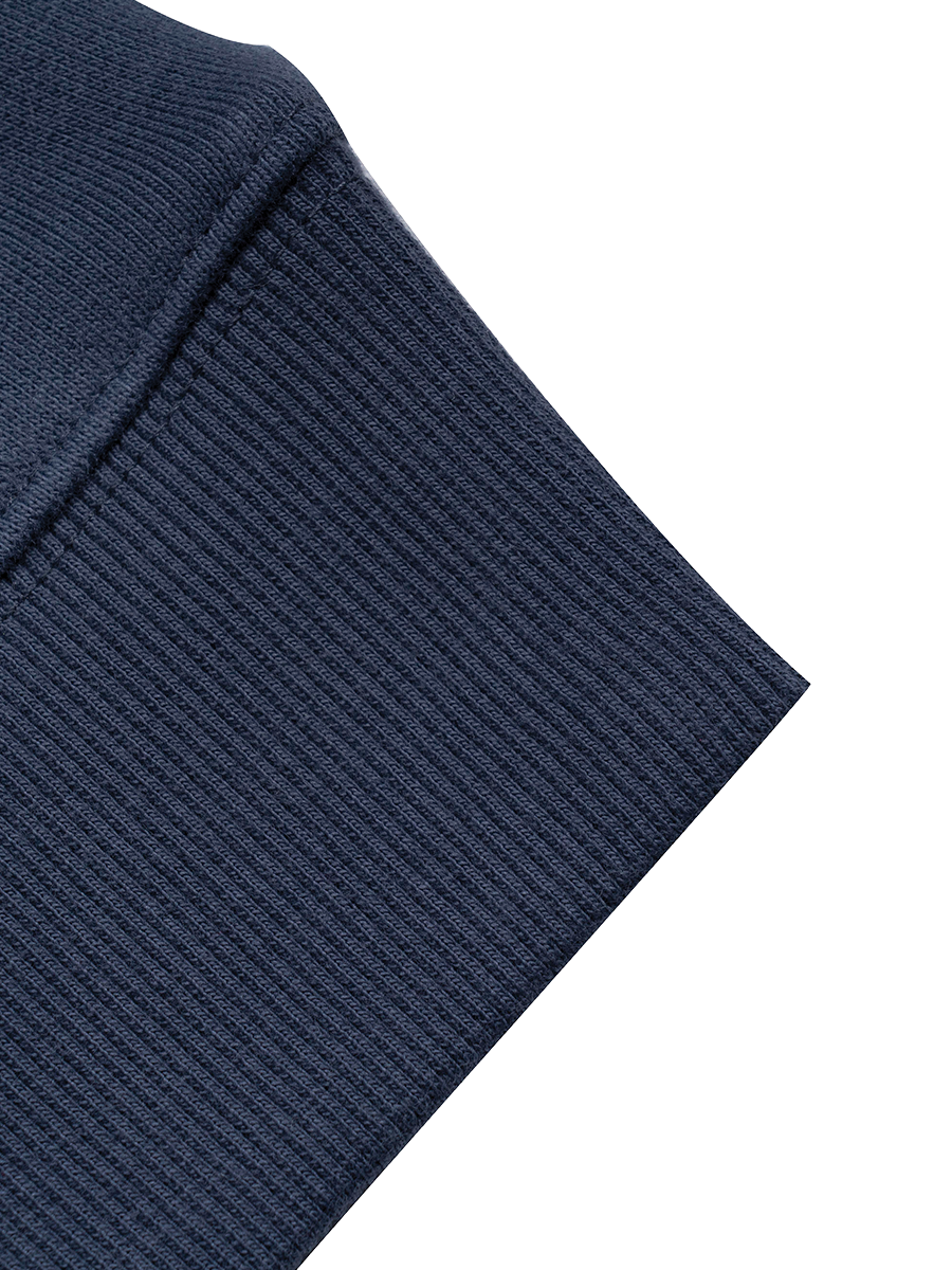 Close-up of a navy blue crewneck sleeve on a white background