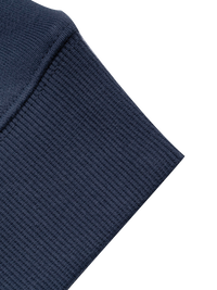 Close-up of a navy blue crewneck sleeve on a white background