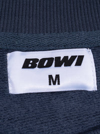 Navy blue fabric with a 'BOWI' label and size 'M'.