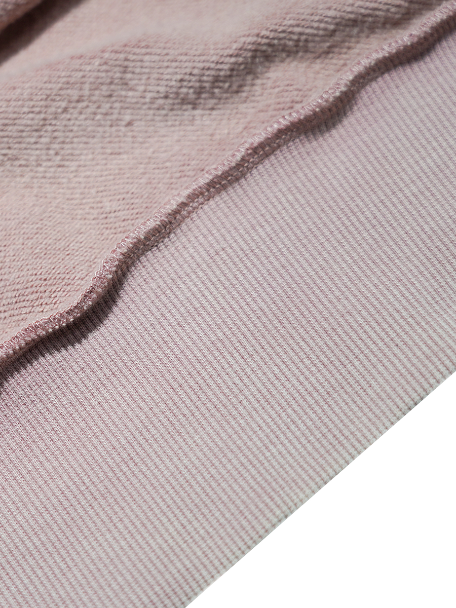 Close-up of a textured pink fabric with a white background