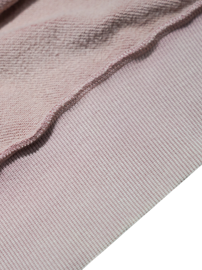 Close-up of a textured pink fabric with a white background