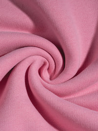 Close-up of pink fabric with a swirl pattern