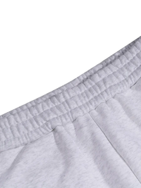 Close-up of gray sweatpants with a white background